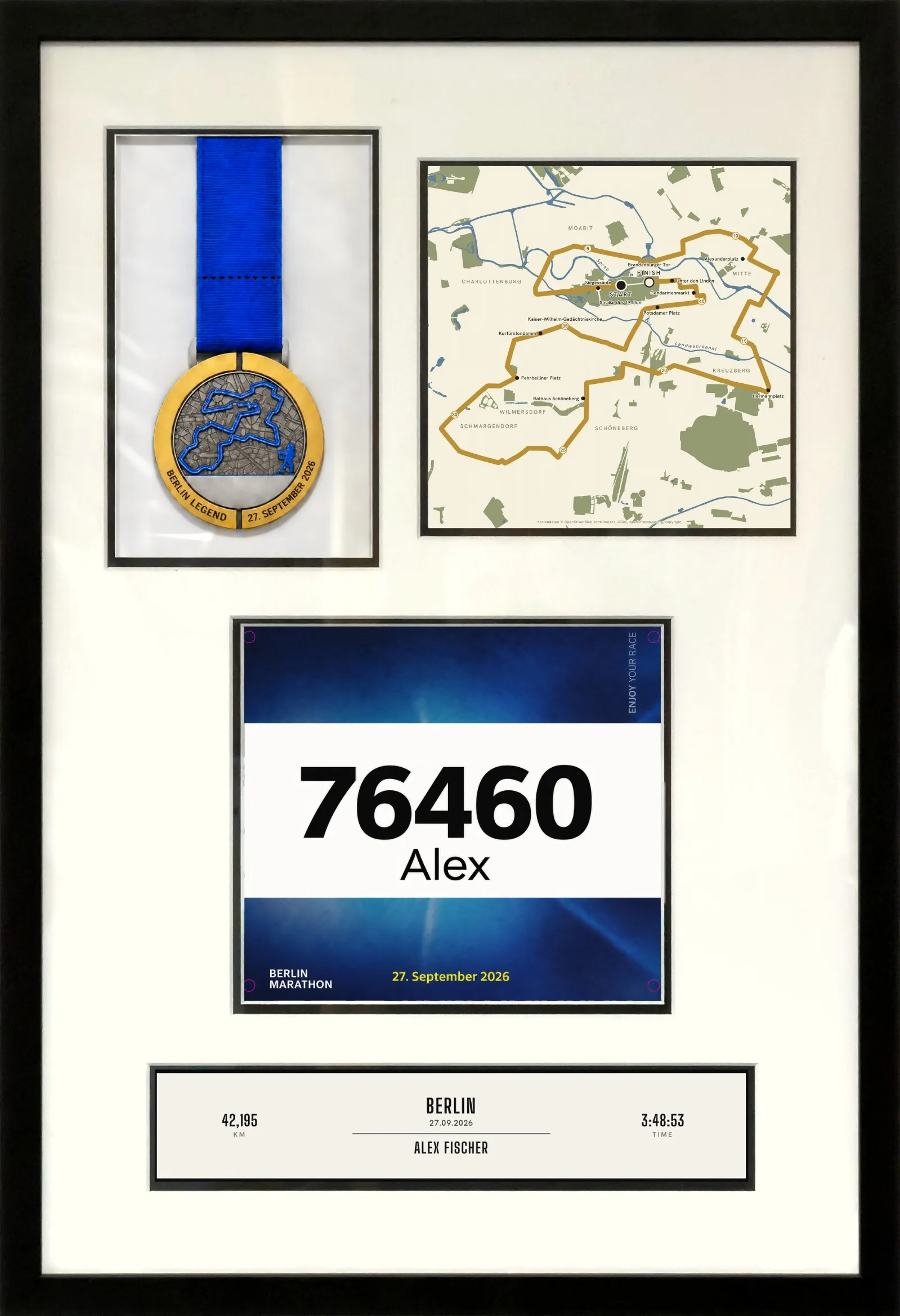 A black frame in 40 by 60 format on a light wall. Behind a white mount sit a medal on a blue ribbon, the route map of the Berlin marathon on cream poster paper, a bib number and below it the printed finisher line with distance, place, date, name and finish time.